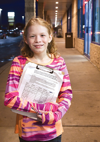 MARK NANCE/Sun-Gazette Madison Wertz, 11, of Loyalsock Township, shows off the petition for which she has been collecting signatures to urge better funding for rape test kits.
